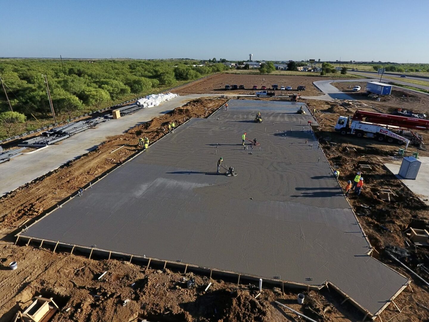 A concrete slab being poured for a building.