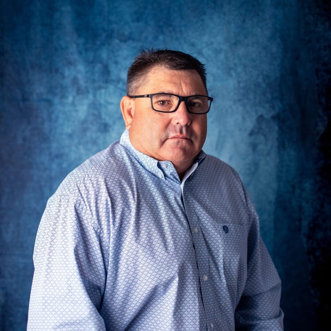 A man in glasses and a blue shirt